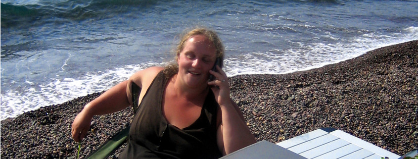 Lara telefoniert am Strand